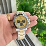 Showcasing Rolex Daytona Golden 42 First Copy Watch man holding it in his hand