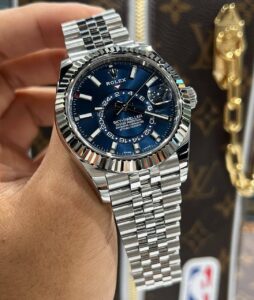 Showcasing the Rolex SKYDWELLER Blue 42 First Copy Watch on a man hand with bright lighting