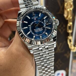 Showcasing the Rolex SKYDWELLER Blue 42 First Copy Watch on a man hand with bright lighting