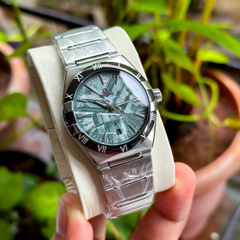 Omega Constellation – green meteorite first copy with black bezel.